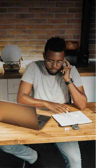 man working with notebook and macbook