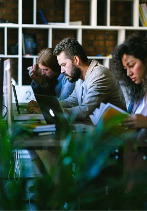 team working on computers and also readsing